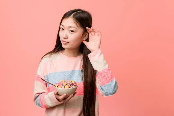 Young Asian Woman Cereal Bowl Trying Listening Gossip — Stockfoto