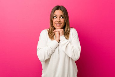 Bir duvara karşı Genç otantik karizmatik gerçek insanlar kadın çene altında ellerini tutar, bir kenara mutlu bakıyor.