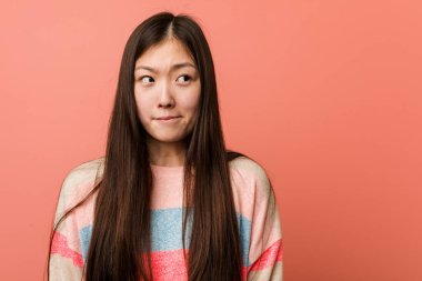 Genç havalı Çinli kadının kafası karışık, kuşkulu ve kararsız..