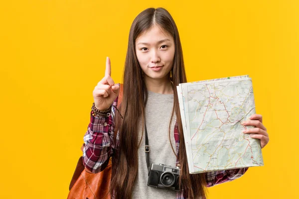 Young Asian Woman Holding Map Showing Number One Finger — Zdjęcie stockowe