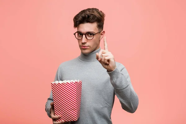 Young Intellectual Man Holding Popcorn Bucket Showing Number Two Fingers — Stock Photo, Image