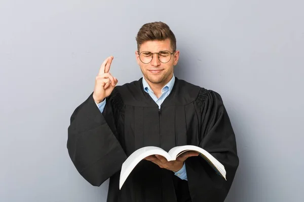 Young Jurist Holding Book Crossing Fingers Having Luck — Stock Photo, Image