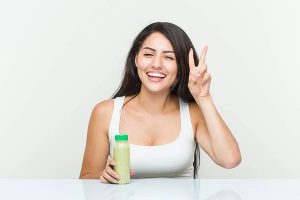 Young Hispanic Woman Holding Vegetable Drink Showing Victory Sign Smiling — Stock Photo, Image