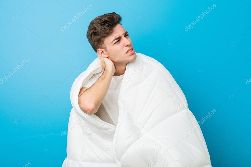 Teenager caucasian tired man covering himself with a blanket
