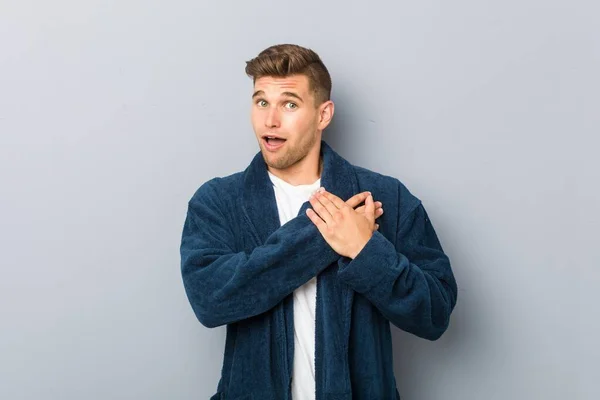 Young Caucasian Man Wearing Pajama Has Friendly Expression Pressing Palm — Stock Photo, Image