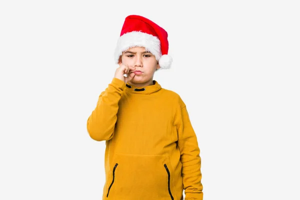 Mały Chłopiec Świętujący Boże Narodzenie Kapeluszu Mikołaja Odizolowany Palcami Ust — Zdjęcie stockowe