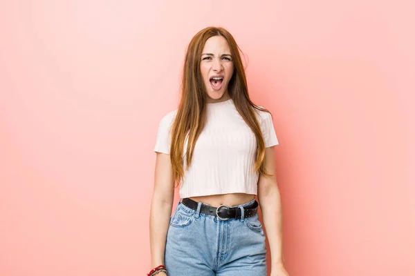 Young Redhead Ginger Woman Pink Wall Screaming Very Angry Aggressive — Stock Photo, Image