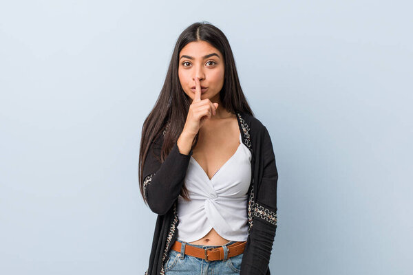 Young natural and pretty arab woman keeping a secret or asking for silence.