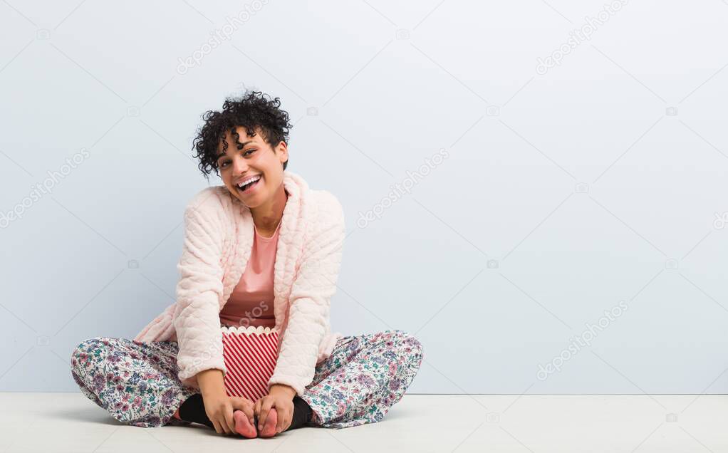 Young african american woman sitting holding a popcorn box