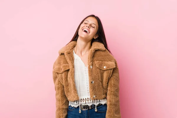 Young cute woman relaxed and happy laughing, neck stretched showing teeth.