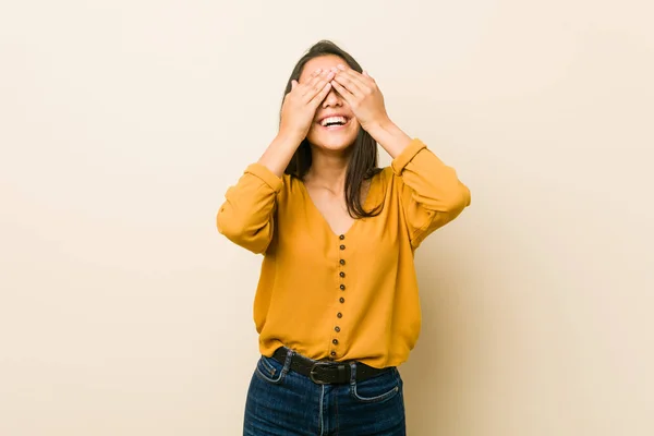 Young Hispanic Woman Beige Background Covers Eyes Hands Smiles Broadly — 图库照片