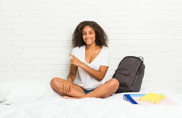 Young African American Student Woman Bed Smiling Pointing Aside Showing — Stock Photo, Image