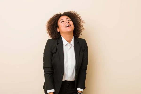 Young business african american woman relaxed and happy laughing, neck stretched showing teeth.