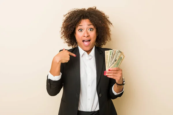 Young African American Woman Holding Dollars Surprised Pointing Himself Smiling — Stock Photo, Image