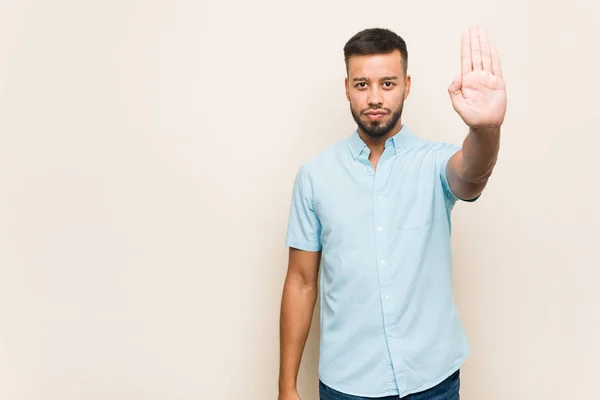 Ung Sydasiatisk Man Står Med Utsträckt Hand Visar Stoppskylt Hindrar — Stockfoto