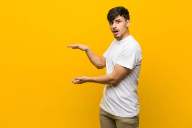 Genç Latin asıllı sıradan bir adam ellerinin arasında bir kopyayı tutarken şok oldu ve hayrete düştü..