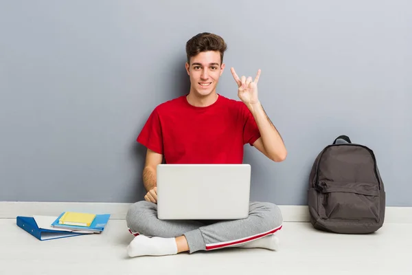 Jonge student man zittend op zijn huis vloer met een laptop — Stockfoto