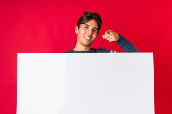 Young Man Holding Placard Cheerful Smiles Pointing Front — Stock Photo, Image