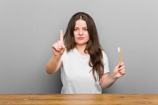 Young Size Curvy Woman Holding Toothbrush Showing Number One Finger — Stock Photo, Image