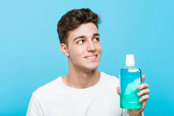 Young Caucasian Man Holding Mouthwash Smiling Confident Crossed Arms — Stock Photo, Image