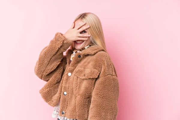 Young Blonde Woman Wearing Coat Pink Background Blink Camera Fingers — Stockfoto