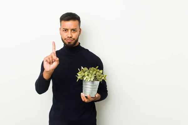 Młody Mężczyzna Azji Południowej Trzymający Roślinę Numer Jeden Palcem — Zdjęcie stockowe