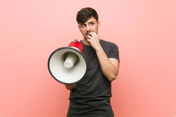 Young Hispanic Man Holding Megaphone Relaxed Thinking Something Looking Copy — Stock Photo, Image