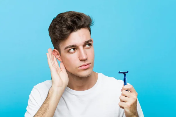 Young Caucasian Man Holding Razor Blade Trying Listening Gossip — Stock Photo, Image