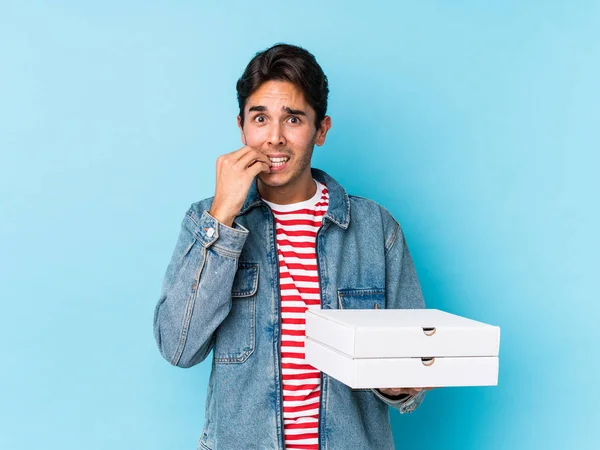 Young Caucasian Man Holding Pizzas Isolated Biting Fingernails Nervous Very — 스톡 사진
