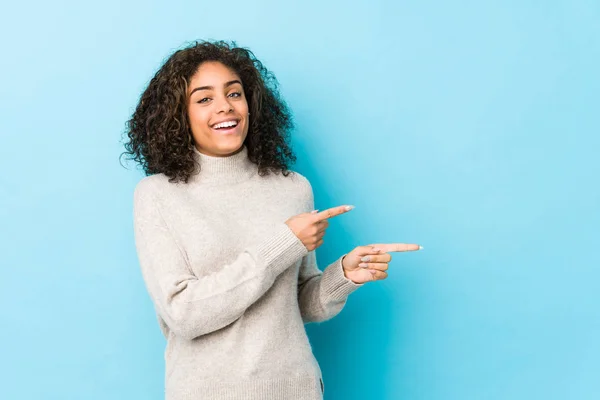Young African American Curly Hair Woman Excited Pointing Forefingers Away — 스톡 사진