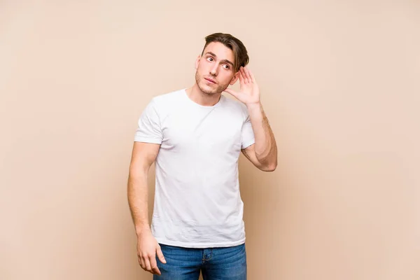 Young Caucasian Man Posing Isolated Trying Listening Gossip — 图库照片