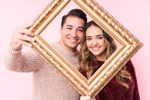 Young Latin Couple Holding Frame — 스톡 사진