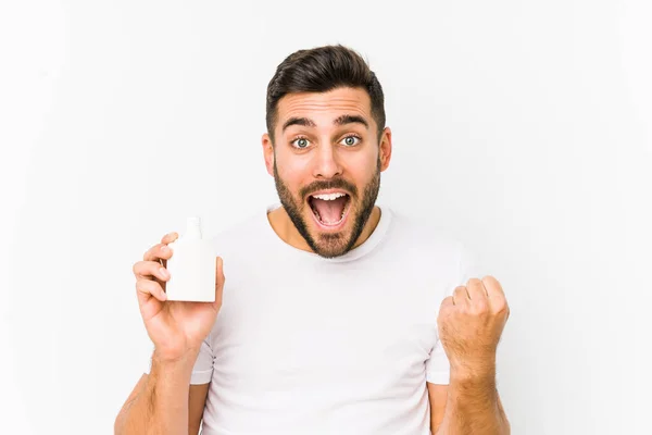 Young Caucasian Man Holding Vitamins Bottle Isolated Cheering Carefree Excited — Stock fotografie