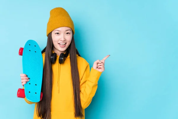 Joven Patinadora China Aislada Sonriendo Señalando Lado Mostrando Algo Espacio —  Fotos de Stock