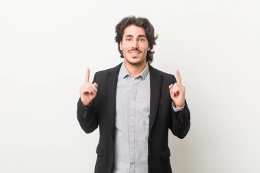 Beyaz bir geçmişi olan genç bir iş adamı iki parmağını da boş bir alan gösterdiğini gösteriyor..