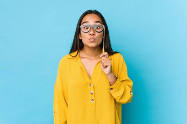 Genç Hintli kadın eğleniyor ve parti objelerini soyutluyor.