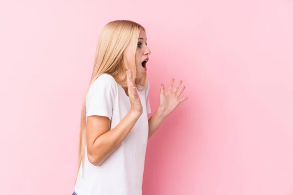Young Blonde Woman Pink Background Shouts Loud Keeps Eyes Opened — Stock Photo, Image