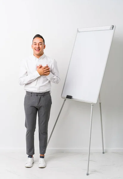 Young Latin Coaching Man Whiteboard Isolated Laughing Keeping Hands Heart — Stock Photo, Image