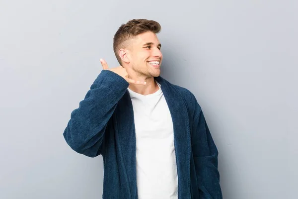 Young Caucasian Man Wearing Pajama Showing Mobile Phone Call Gesture — 스톡 사진