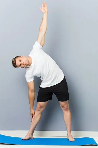 Young caucasian man practicing yoga indoor — Stock Photo, Image