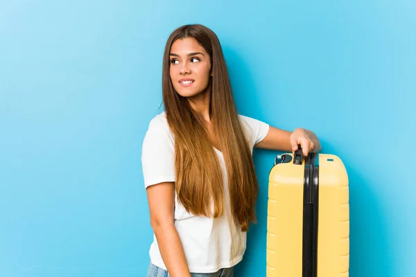 Young Caucasian Woman Holding Travel Suitcase Looks Aside Smiling Cheerful — Stok fotoğraf