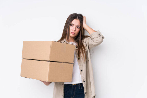 Young caucasian woman moving to a new home being shocked, she has remembered important meeting.
