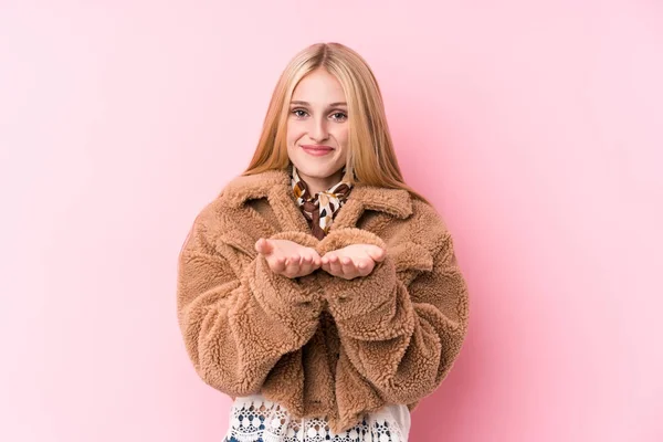 Young Blonde Woman Wearing Coat Pink Background Holding Something Palms — Stock Photo, Image