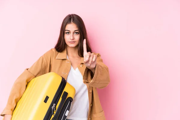 Young Caucasian Traveler Woman Holding Suitcase Isolatedshowing Number One Finger — Stock Photo, Image