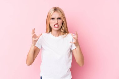 Pembe arka plandaki genç sarışın kadın gergin elleriyle çığlık atıyor..