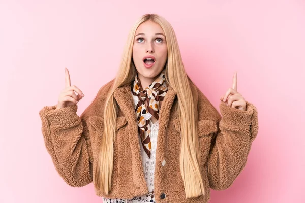 Ung Blond Kvinna Bär Rock Mot Rosa Bakgrund Pekar Upp — Stockfoto