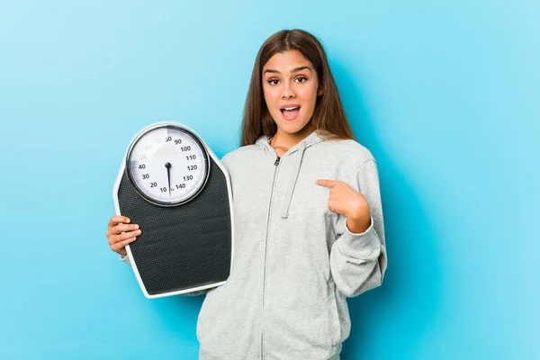 Young Fitness Woman Holding Scale Surprised Pointing Himself Smiling Broadly — Stock Photo, Image