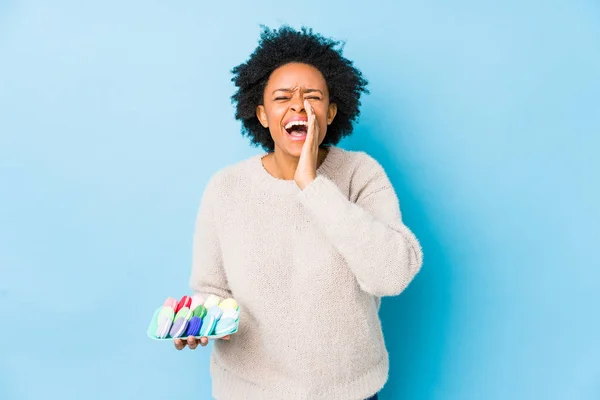 Middle Age African American Woman Eating Macaroons Isolated Shouting Excited — 스톡 사진