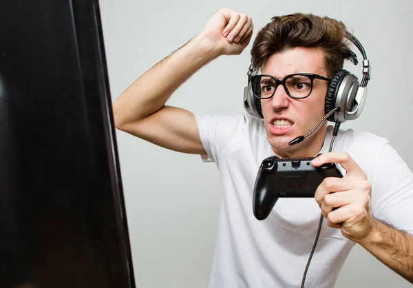 Person playing video games with controller on computer. Player using  joystick and wearing headphones to play online game on monitor. Modern man  using gaming equipment to have fun Stock Photo - Alamy