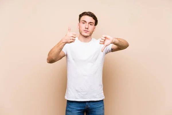 Young Caucasian Man Posing Isolated Showing Thumbs Thumbs Difficult Choose — Stock Photo, Image